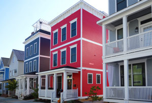 Red, blue, and gray multiple story colored homes with white trim